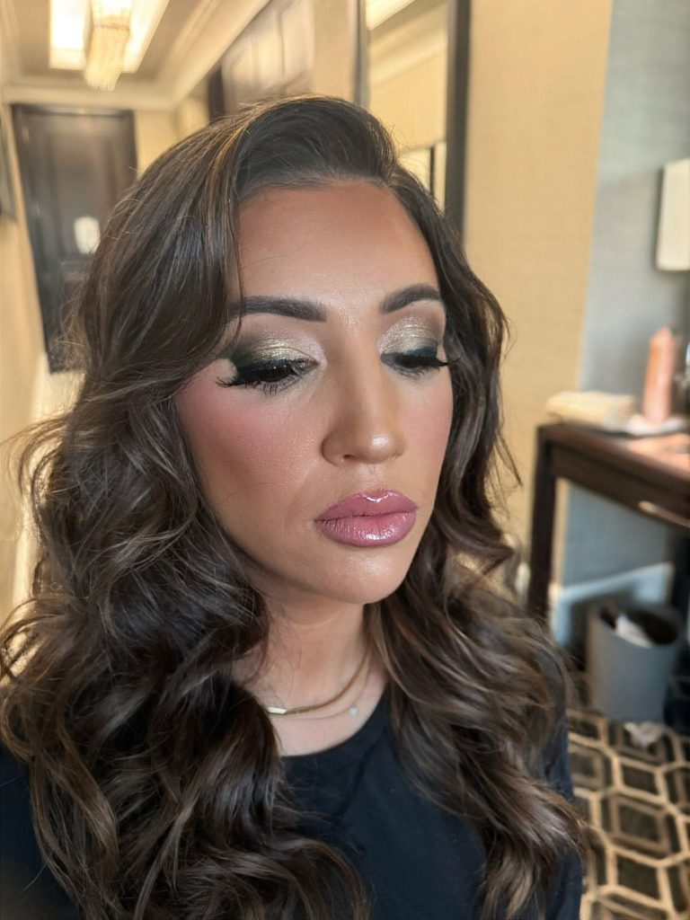 Shimmering eye makeup, glossy rose lips and brunette waves