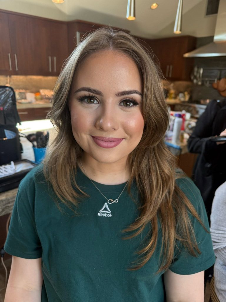 Soft natural makeup with pink lips and loosely waved hair